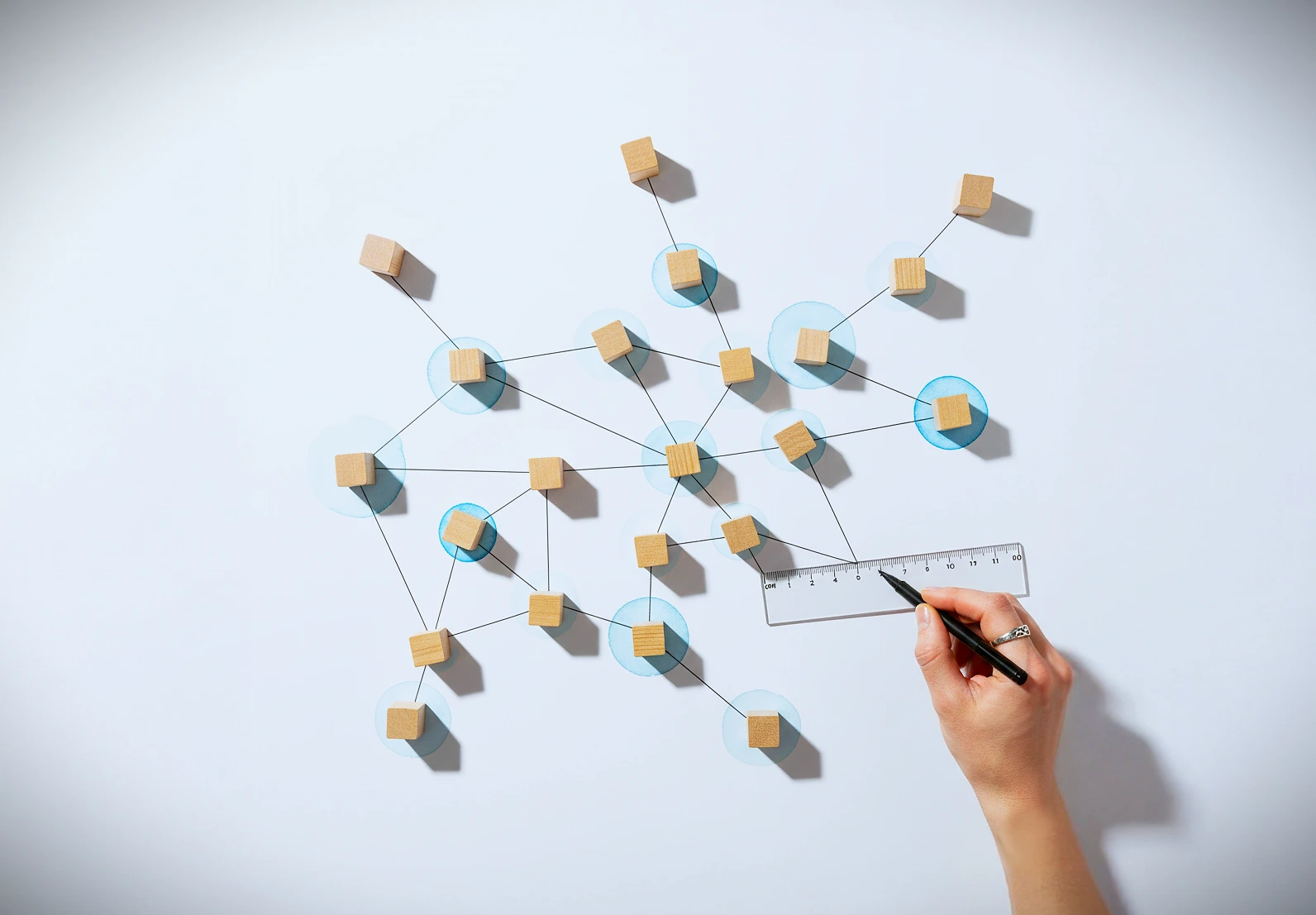 A woman's hand holding a blue cup with butterflies on it.